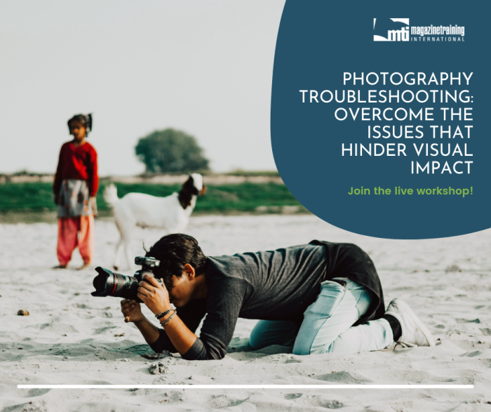 Indian man laying in the sand to take a photo with a camera