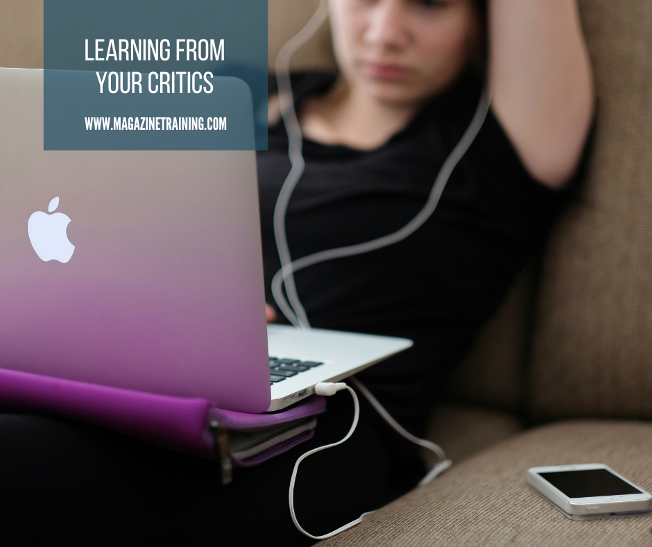 person using computer with headphones in